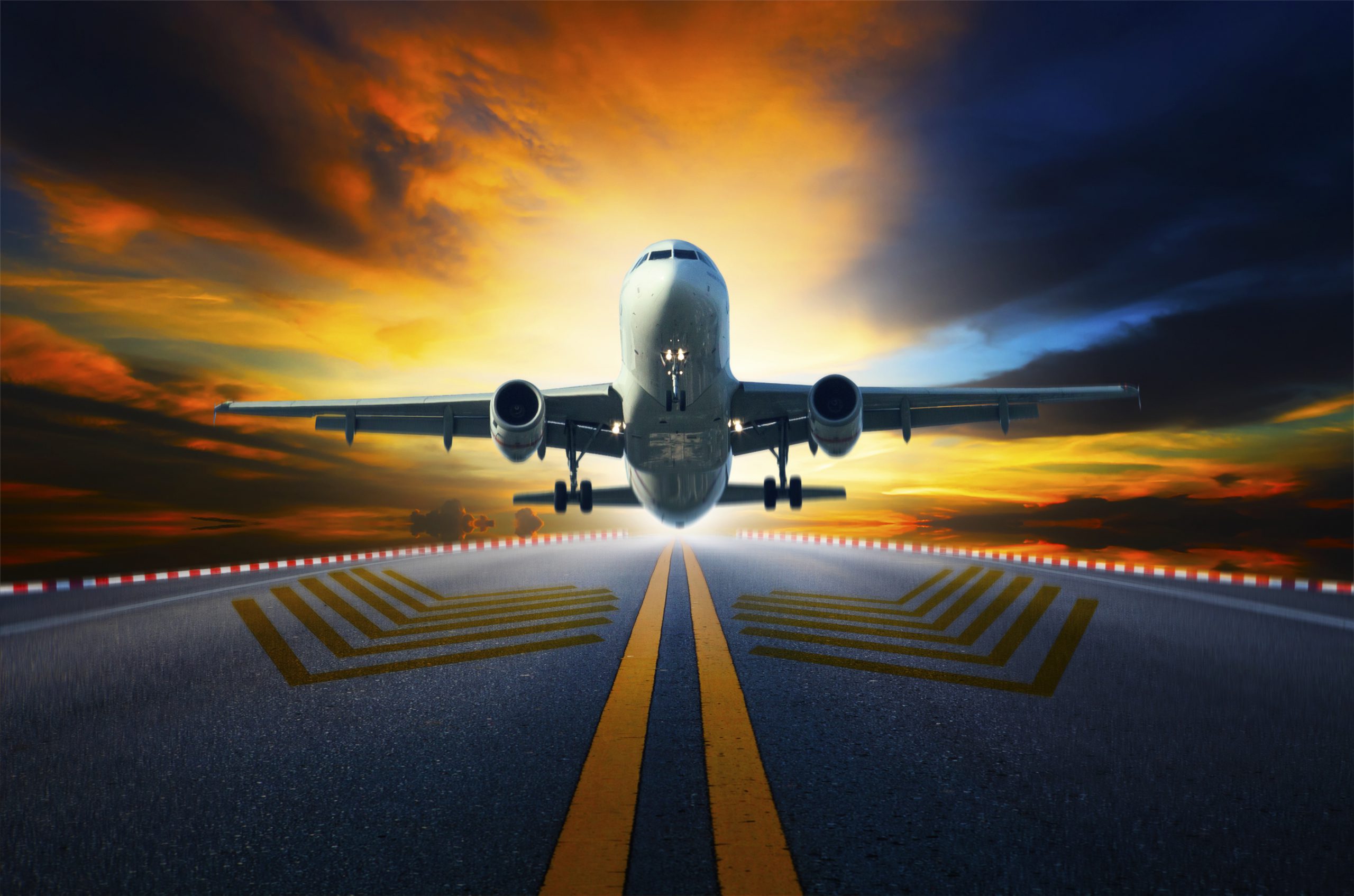 passenger jet plane preparing to take off from airport runways with motion blur against beautiful dusky sky